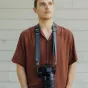 Peak Design Slide Lite Ocean camera strap with Anchor Link system worn as a shoulder and neck strap, ideal for Fujifilm mirrorless cameras