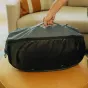 Peak Design Travel Duffelpack 65L ocean grey expandable duffel bag with stowable shoulder and waist harness, shown closed with top handle grip