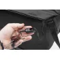 Detail of the magnetic clasp on the black Peak Design Everyday Tote V2 15L, featuring a car key fob attached to the interior pocket.