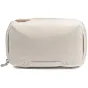 Peak Design Tech Pouch in bone color, front view featuring elastic loops and durable zipper closure for organized tech storage