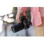 Tamron 17-70mm F2.8 Di III-A VC RXD lens for Canon RF APS-C cameras held in portrait orientation, showcasing front element and lens hood details.