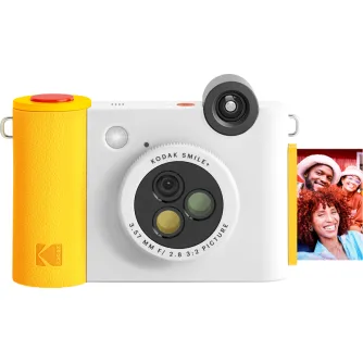 Kodak Smile+ instant camera with a yellow and white body, featuring a rotating lens and a printed photo of smiling people in winter hats.