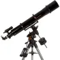 Celestron Advanced VX 6 Refractor telescope mounted on a silver tripod with a remote control, featuring a dual saddle plate and orange adjustment knob.