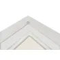 White photo frame with a white matte border and beige inner section, empty, corner view