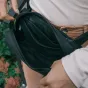 Wandrd D1 Fanny Pack with magnetic buckle, partially unzipped to reveal multiple compartments for secure travel essentials