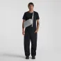 URTH Dolomite 5.1L camera sling in stone gray, worn crossbody by a model, featuring weatherproof recycled nylon and adjustable strap