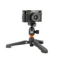 3 Legged Thing Airhed Mini Arca QR Ballhead in dark matte black, featuring a twist lock clamp, 360° pan knob, and quick-release plate, mounted on a tripod with adjustable legs and rubber feet, supporting a camera.