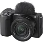 Sony ZV-E10 mirrorless camera with 16-50mm OSS II lens, directional 3-capsule microphone with windscreen adapter, textured grip, vari-angle LCD screen, and red recording indicator light for vlogging and content creation.