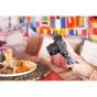 Sony ZV-E10 mirrorless camera with 16-50mm OSS II lens, handheld grip, and advanced autofocus, capturing a plate of food on a woven placemat.