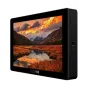 SmallHD Cine 7 ARRI Kit 7‑inch on‑camera monitor displaying a vivid autumn mountain landscape with lake reflection, side view shows its black aluminum chassis, side ports and ¼‑20 mounting points.