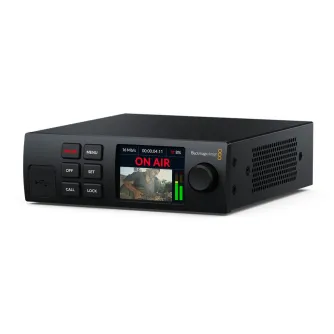 Blackmagic Streaming Encoder HD with digital screen displaying 'ON AIR', video preview of a guitarist, and green audio level meters. Control buttons include 'ON AIR', 'MENU', 'OFF', 'SET', 'CALL', 'LOCK', and a USB port. Blackma