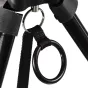 Close-up of a black Cartoni Focus tripod's upper joint with a silver hinge and a black rubber strap attached to a black plastic ring. The tripod legs are partially visible against a plain white background.