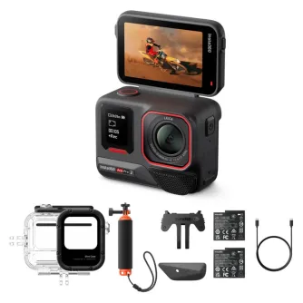 Insta360 Ace Pro 2 action camera with a flip-up 2.5-inch touchscreen displaying a motocross rider, accompanied by a clear dive case, floating handle, mounting bracket, batteries, and USB-C cable, representing the complete Dive B