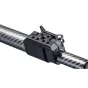 Close-up of Ready Rig Pro Arm Upgrade, a black carbon fiber camera rig arm with a mounting bracket featuring multiple screw holes and a hinge mechanism, attached to a textured carbon fiber tube.