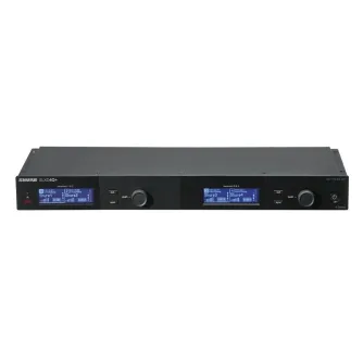 Shure SLXD4Q+ digital 4‑channel broadband receiver with Dante networking, front panel featuring dual LCD displays, a push knob, sync and exit buttons, and a power switch, designed for rack mounting.