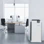 BONECO Air Purifier P710 with digital display showing 254, placed beside a wooden desk and black ergonomic chairs in a modern office, emphasizing quiet performance for large rooms.