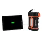 Celestron Powertank Lithium Pro portable power bank charging a tablet, featuring 12V DC, USB ports, LED light panel, and orange accents