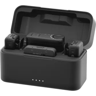GoPro Wireless Mic Complete Kit open charging case containing two clippable transmitters, USB-C and 3.5 mm receivers, and a control module with mode button and gain dial.