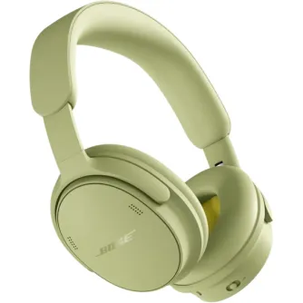 Bose QuietComfort 2. paaudzes bezvadu austiņas ar pārklātu galvaskausu, mīkstiem ausu spilventiņiem un redzamu Bose logotipu, eikalipta zaļā krāsā.