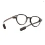Brown EVEN REALITIES G2A AR glasses with detachable microphone modules on the temples, showcasing the sleek magnesium‑alloy frame and titanium temples.