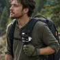 Leofoto QF-03 + QP-38 black backpack quick‑release mount attached to a hiking backpack strap, securing a camera with automatic locking and Arca‑Swiss compatibility for up to 10 kg load.