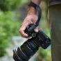 Leofoto WS-02 black quick-detach camera wrist strap with magnetic buckle and adjustable 175-305 mm length, attached to a camera while being held by a hand