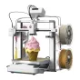 Creality SparkX i7 Nano Combo 3D printer ar multikāršūnu iespēju, parādīts rozīnā glāzētais ķīmnieks uz zelta būves plaknē, divas spīlētas (beiges un zelta) uz labi, un aktivā touchscreen hārads.